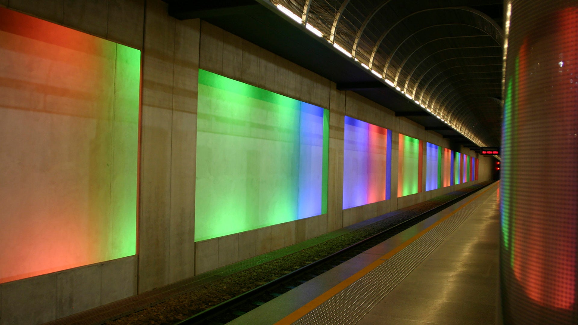 Escalators with green and yellow glass