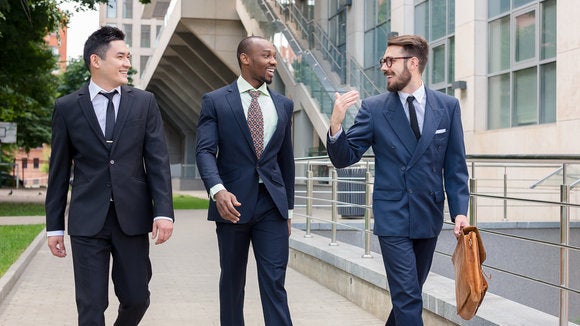 three men in suits walking