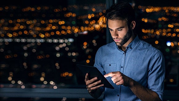 Male professional using tablet for upskilling