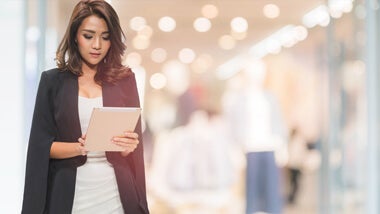 a lady in white shirt touching tablet a lady in white shirt touching tablet